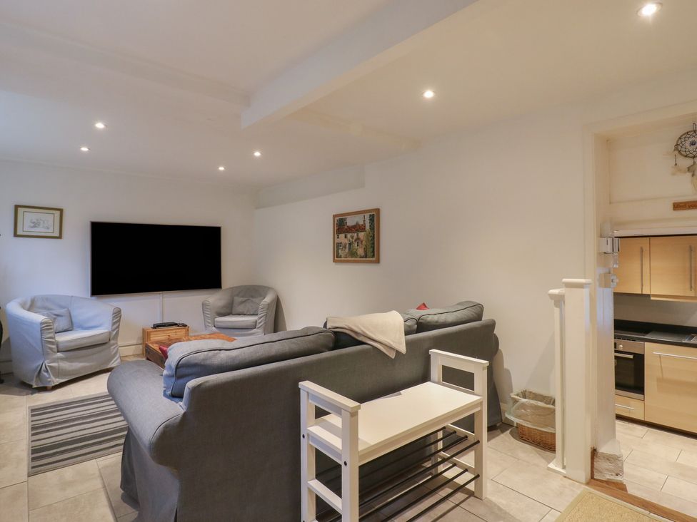 A living room with a sofa and chairs in Cherry Cottage