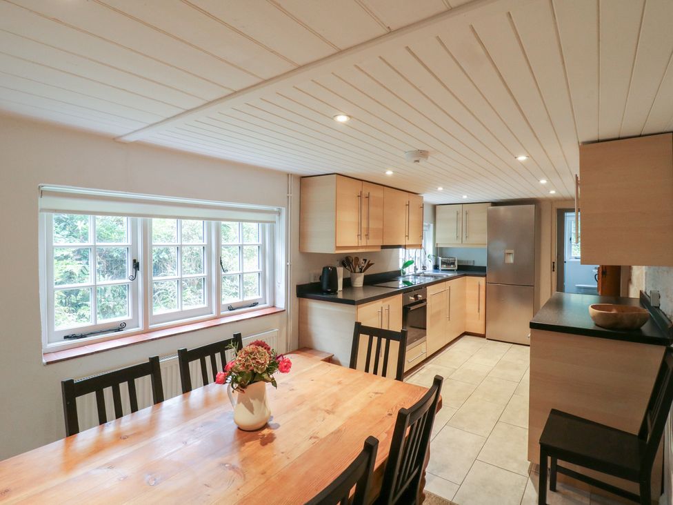 A kitchen with dining table and chairs at Cherry Cottage