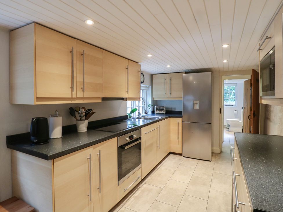 A kitchen with a refrigerator and oven at Cherry Cottage in 
