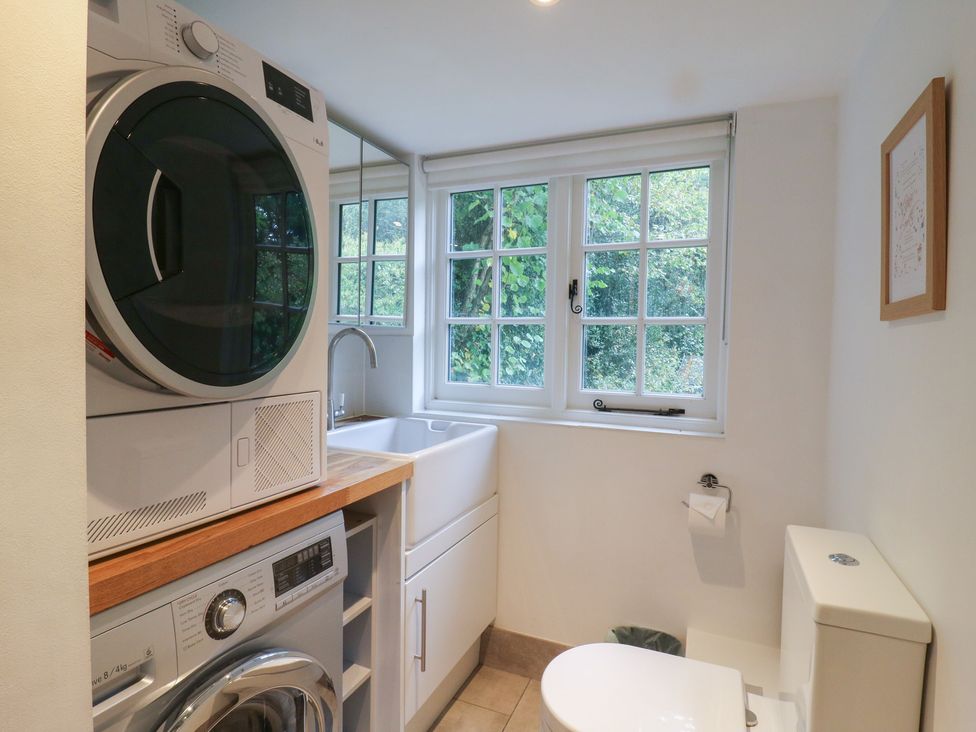 A laundry room with a washing machine and drying machine at Cherry Cottage