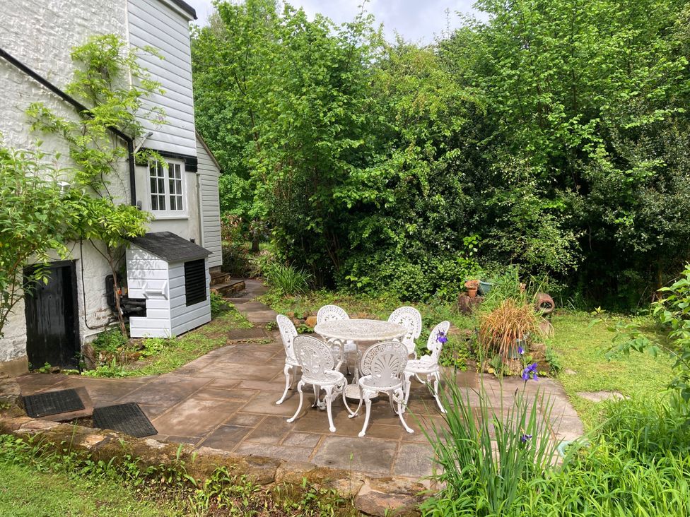 A garden with a table and chairs at Cherry Cottage in Crowborough