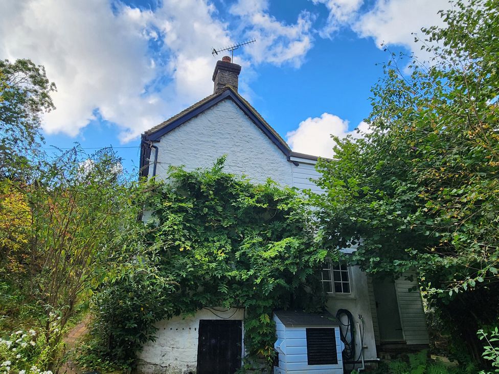 A house with chimney and air conditioning unit at Cherry Cottage in Crowborough