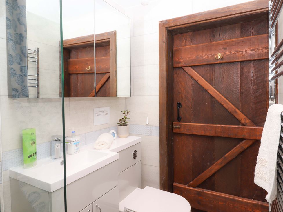A bathroom with a sink and toilet at The Milking Shippon at Thorne, Langtree near Great Torrington
