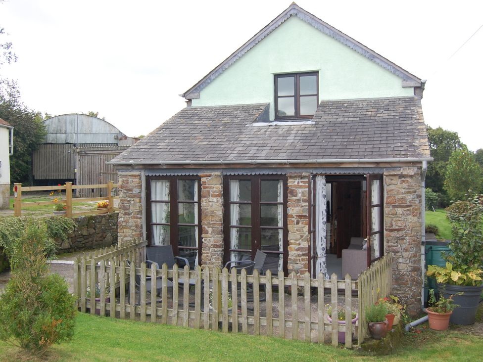 A house with a porch and garden at The Milking Shippon at Thorne Langtree near Great Torrington