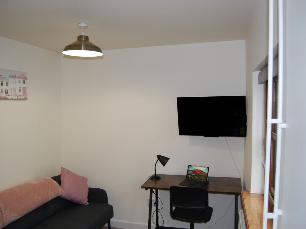 An office with a desk and laptop at The Milking Shippon at Thorne near Great Torrington