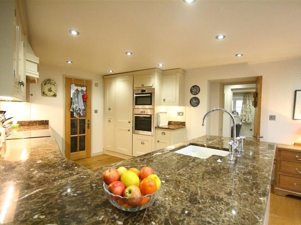 A kitchen with a countertop and appliances at The Coach House in Burford