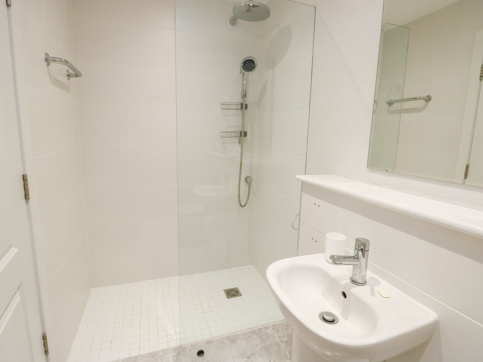 A bathroom with a shower and sink at 2 Lon Y Dryw in Trearddur Bay