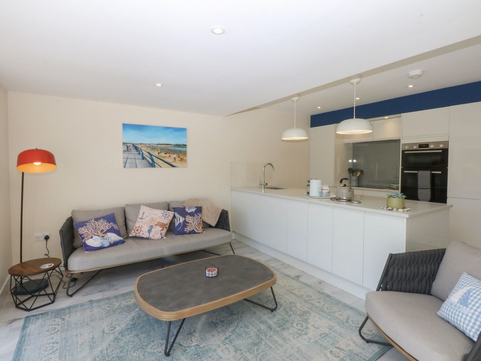 A living room with a sofa and coffee table at 2 Lon Y Dryw in Trearddur Bay