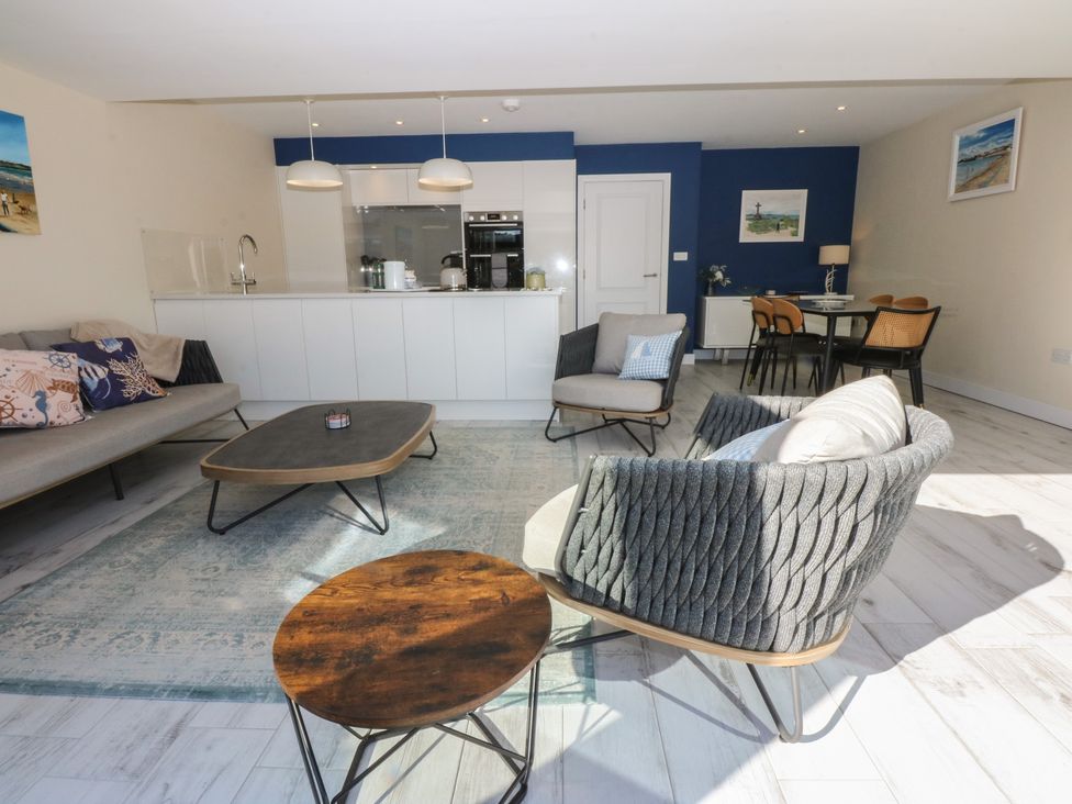 A living room with a sofa and coffee table at 2 Lon Y Dryw in Trearddur Bay