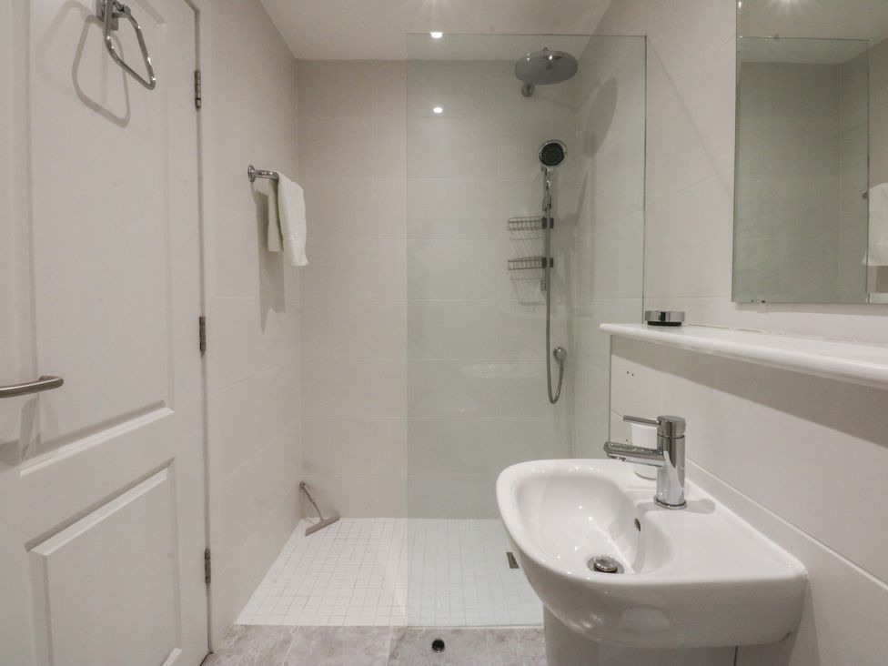 A bathroom with a shower and wash basin at 2 Lon Y Dryw in Trearddur Bay