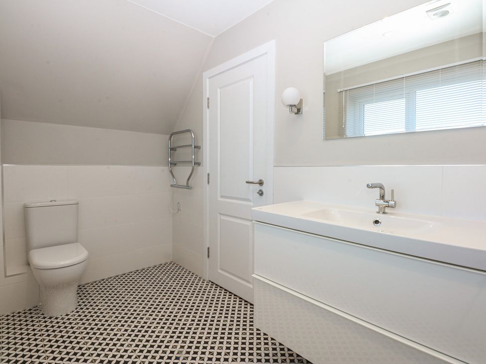 A bathroom with a sink and a toilet at 2 Lon Y Dryw in Trearddur Bay