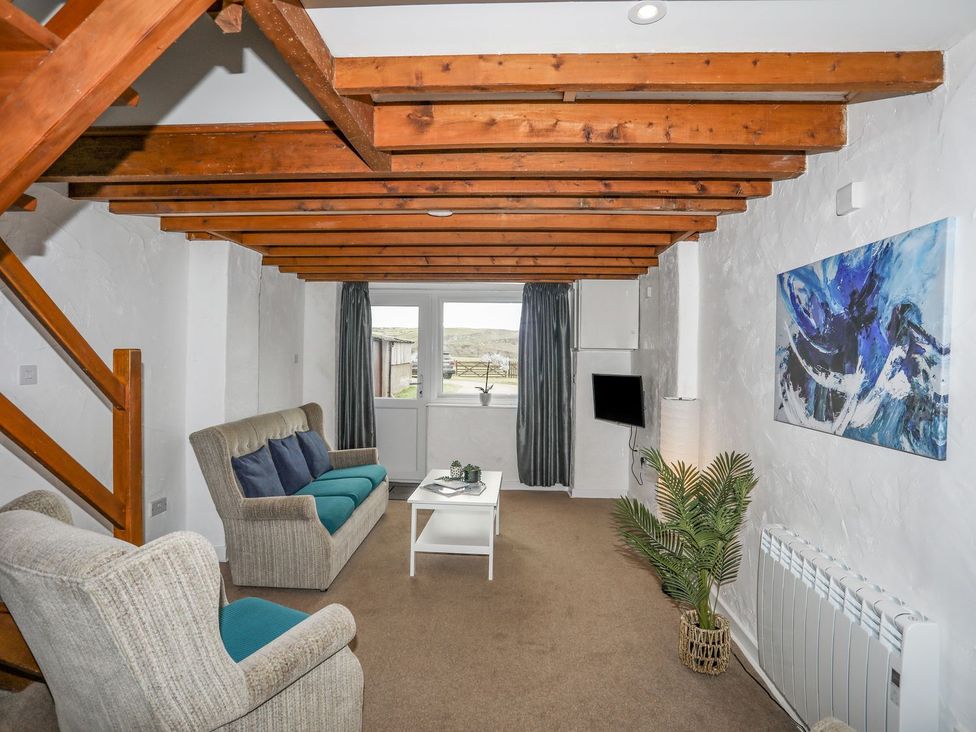 A living room with a sofa and coffee table at Cilan - 2 Ty'n Don Llanengan near Abersoch