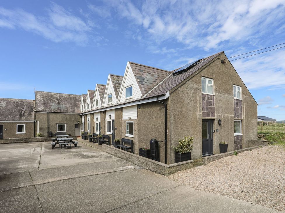 An outdoor area with a building and furniture at Rhiw - 1 Ty'n Don Abersoch