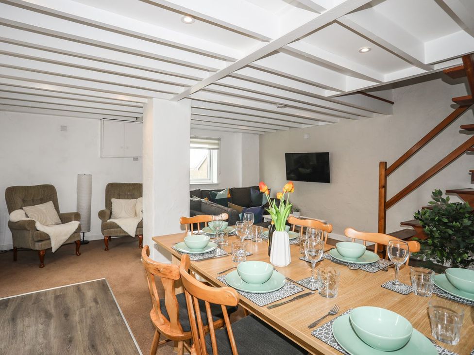A dining room with a table set for dinner at Rhiw - 1 Ty'n Don Abersoch