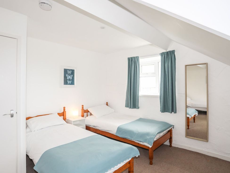 A bedroom with two beds and a window at Rhiw - 1 Ty'n Don in Abersoch