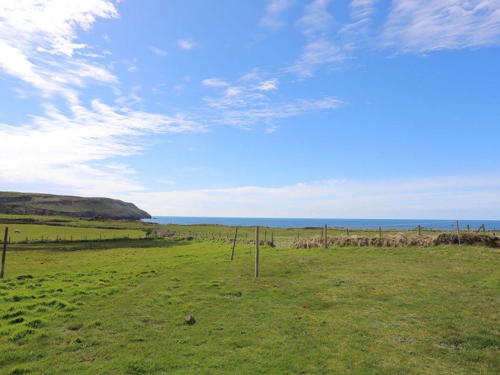 A view of the sea and hills from a grassy area at Rhiw - 1 Ty'n Don Abersoch