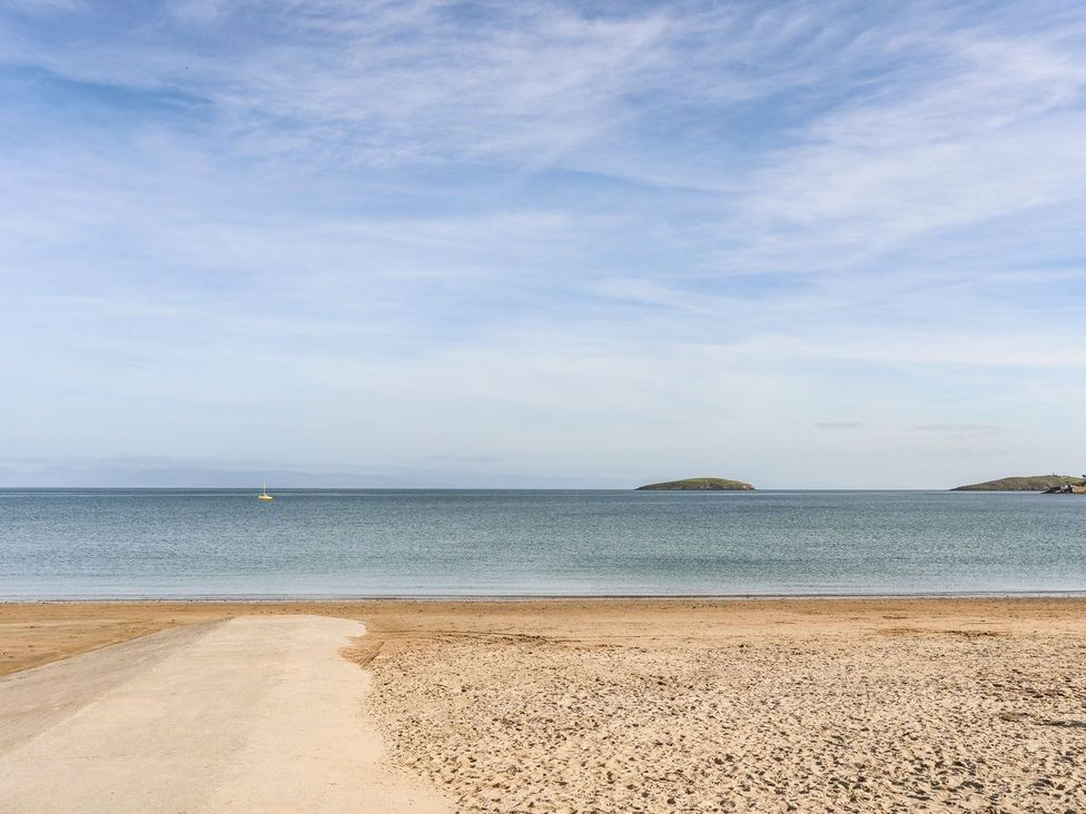 A beach with water and islands in the distance at Rhiw - 1 Ty'n Don Abersoch