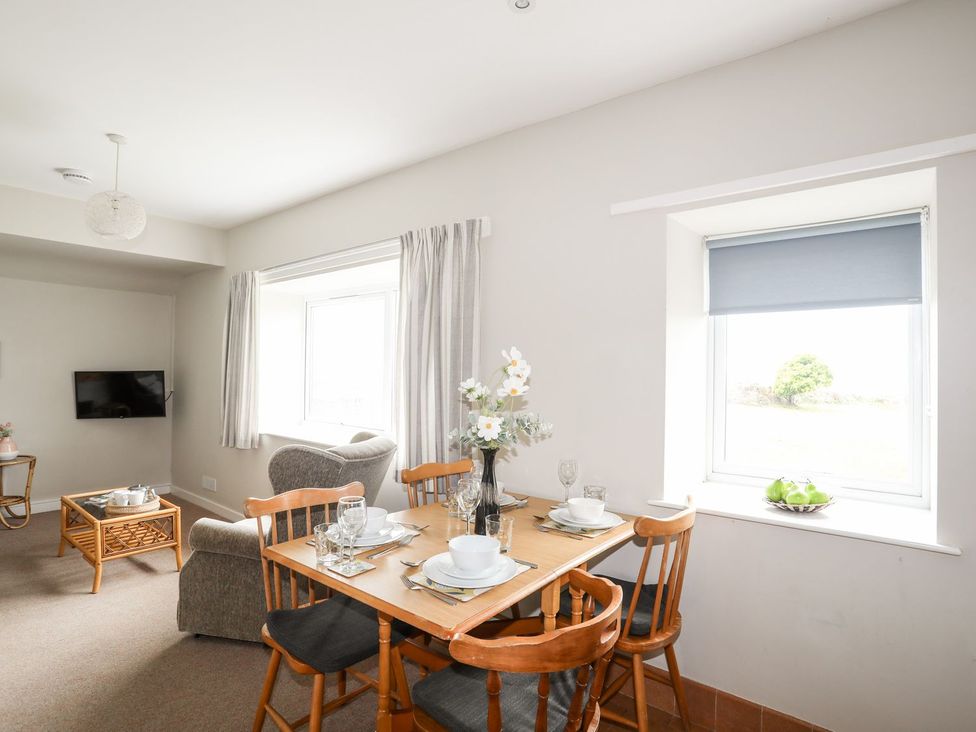 A dining room with a table set for meals at Ceiriad - 9 Ty'n Don Llanengan near Abersoch