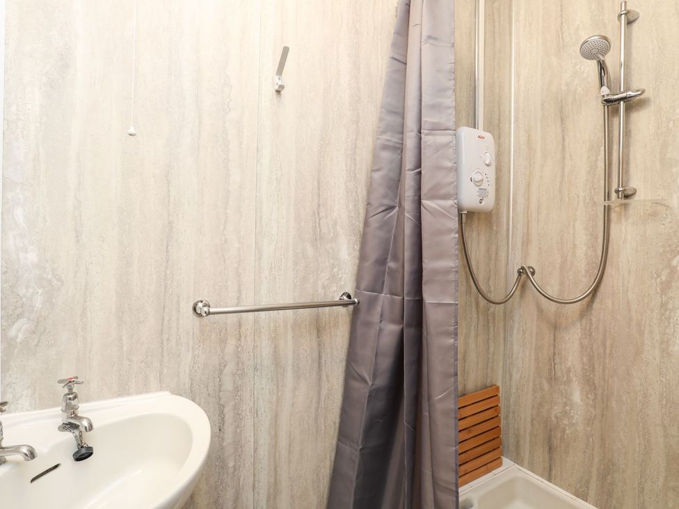A bathroom with a shower and sink at Ceiriad - 9 Ty'n Don in Llanengan near Abersoch