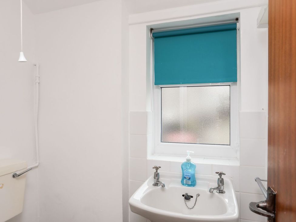 A bathroom with a toilet and sink at Ceiriad - 9 Ty'n Don Llanengan near Abersoch