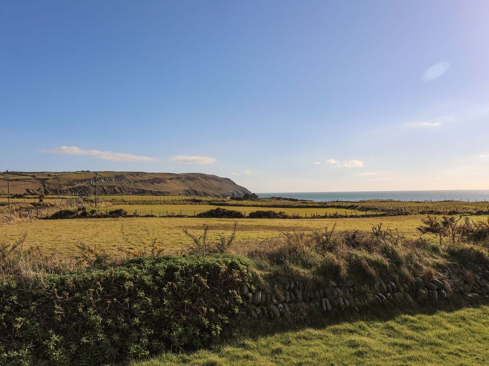 A view of grassland and cliffs by the sea at Ceiriad - 9 Ty'n Don Llanengan near Abersoch