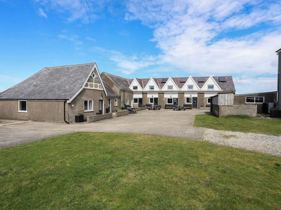 A building exterior with a patio area and benches at Oer - 8 Ty'n Don Llanengan near Abersoch