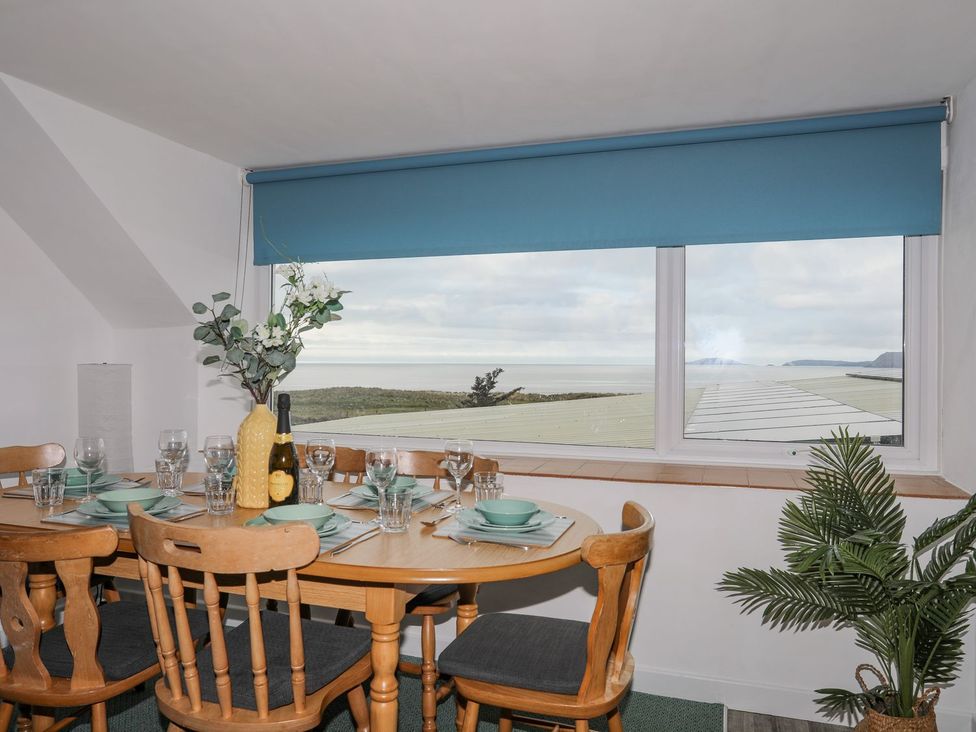A dining room with a table set for meals at Ysgo - 6 Ty'n Don Abersoch