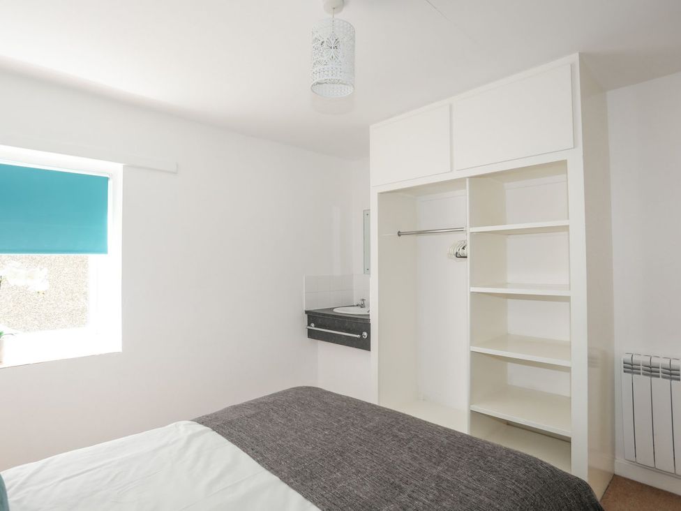 A bedroom with a bed and closet at Ysgo - 6 Ty'n Don Abersoch