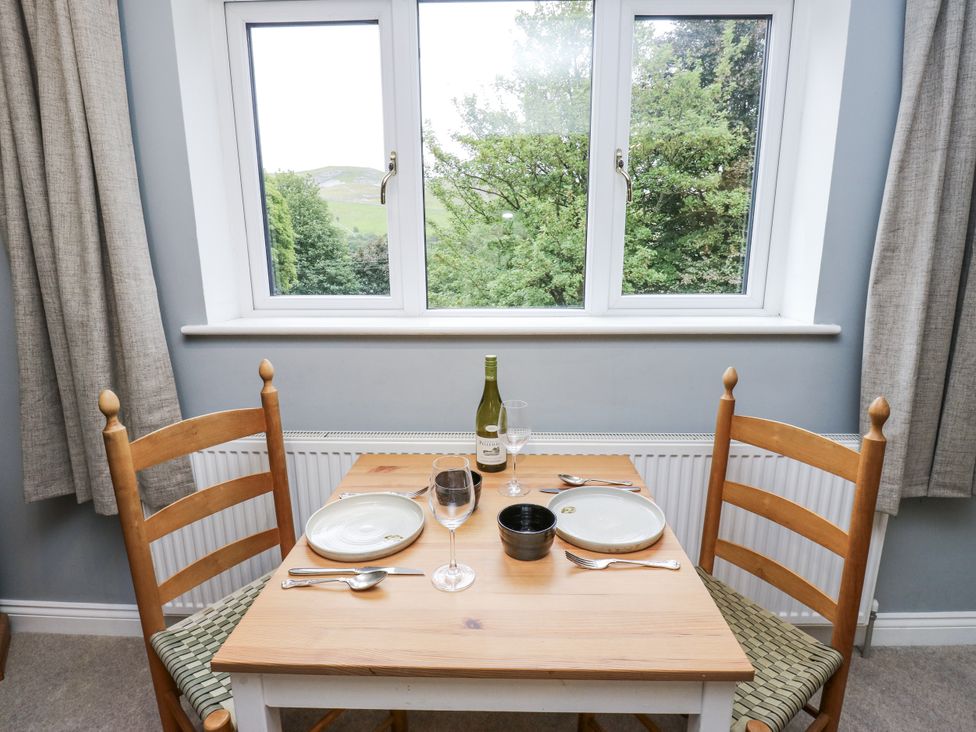 A dining table with chairs and wine bottle at The Treetop 