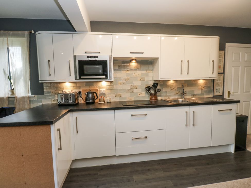 A kitchen with cabinets, a sink, and a countertop at The Treetop 