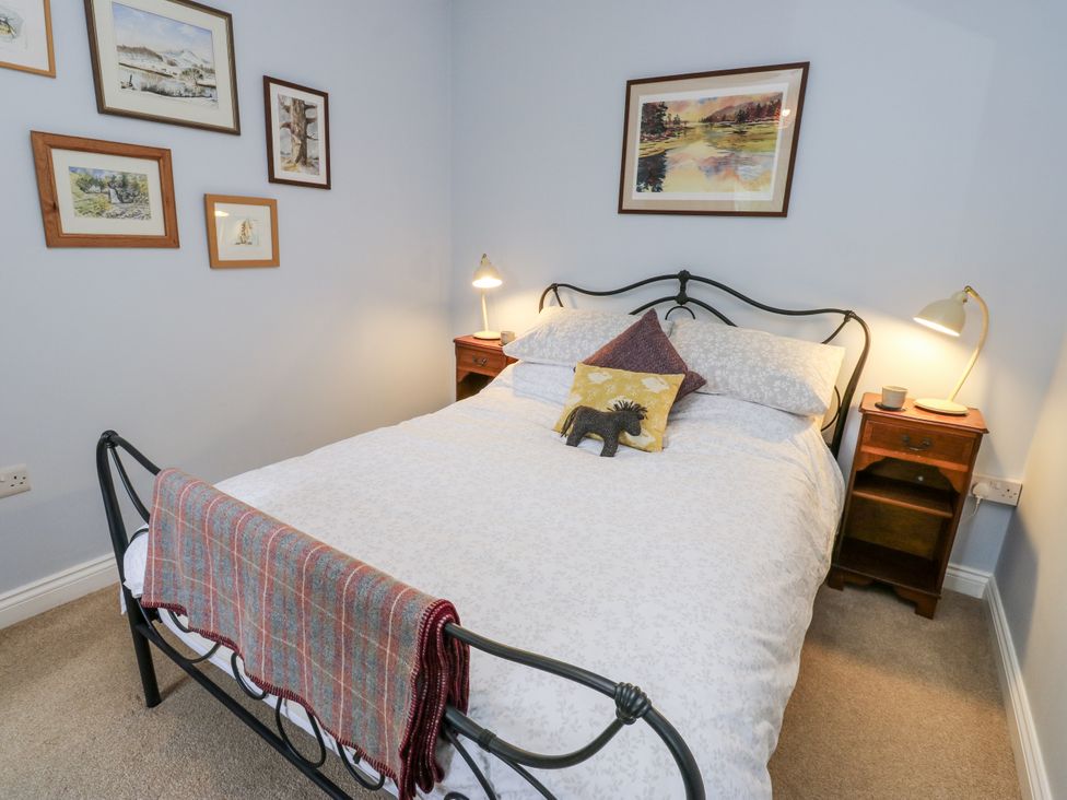 A bedroom with a bed and bedside table at The Treetop