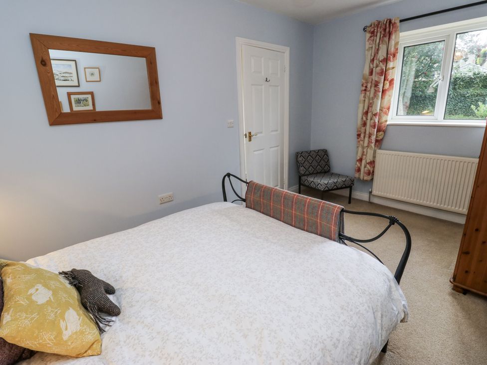 A bedroom with a bed and mirror at The Treetop 