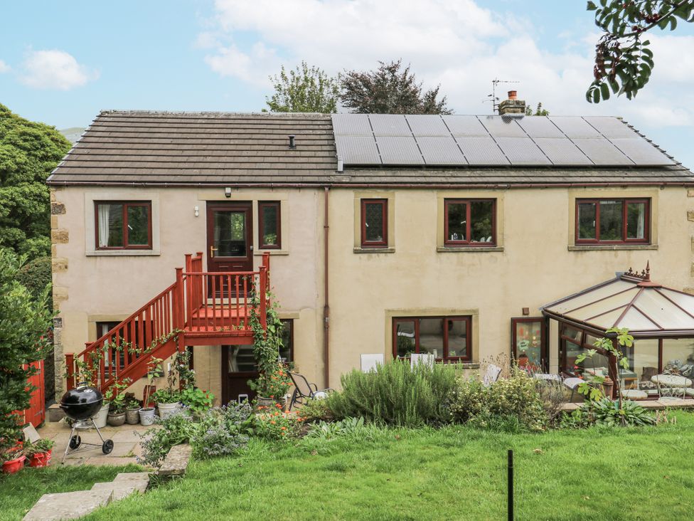 A house with solar panels and a garden at The Treetop 