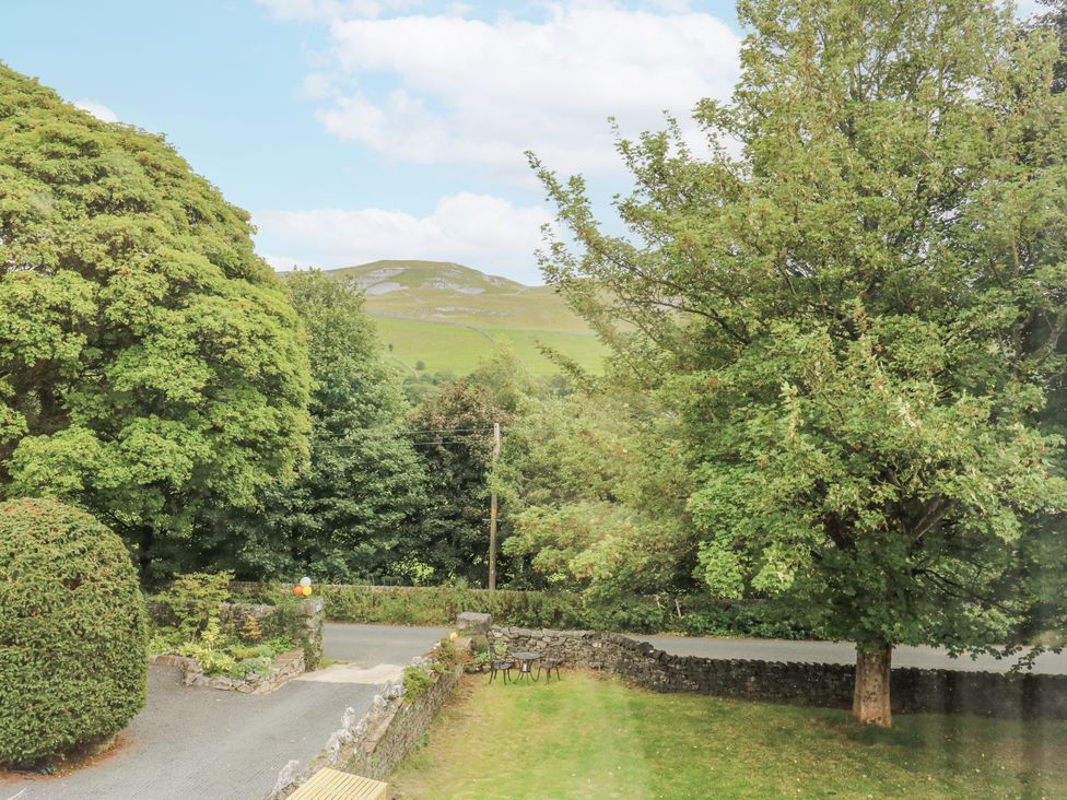 A view of trees and a road with a mountain in the background at The Treetop