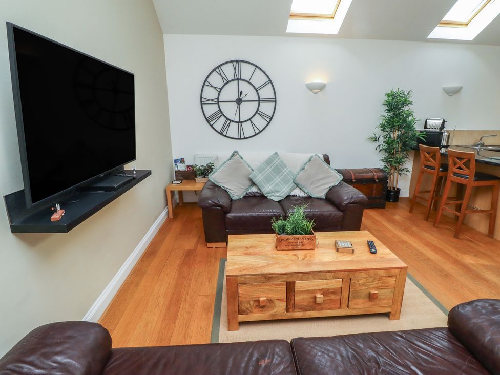 A living room with a television and sofa at Hideaway Cottage No 1 in Seahouses