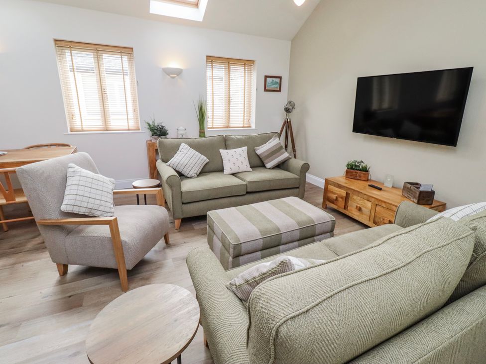 A living room with a sofa and armchairs at Hideaway Cottage No 1 Seahouses