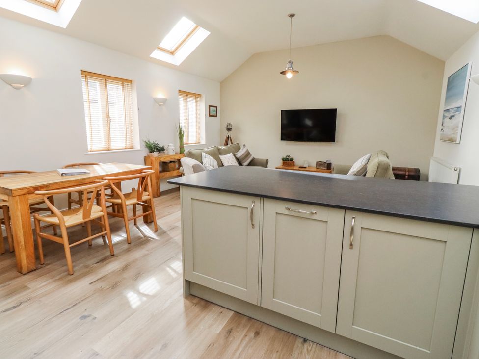 A living room with a table and chairs at Hideaway Cottage No 1 in Seahouses
