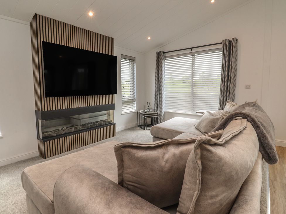 A living room with a sofa and television at Number 35