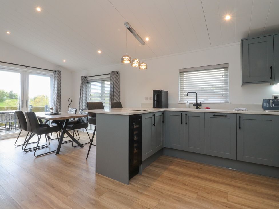 A kitchen with dining area and modern appliances at Number 35