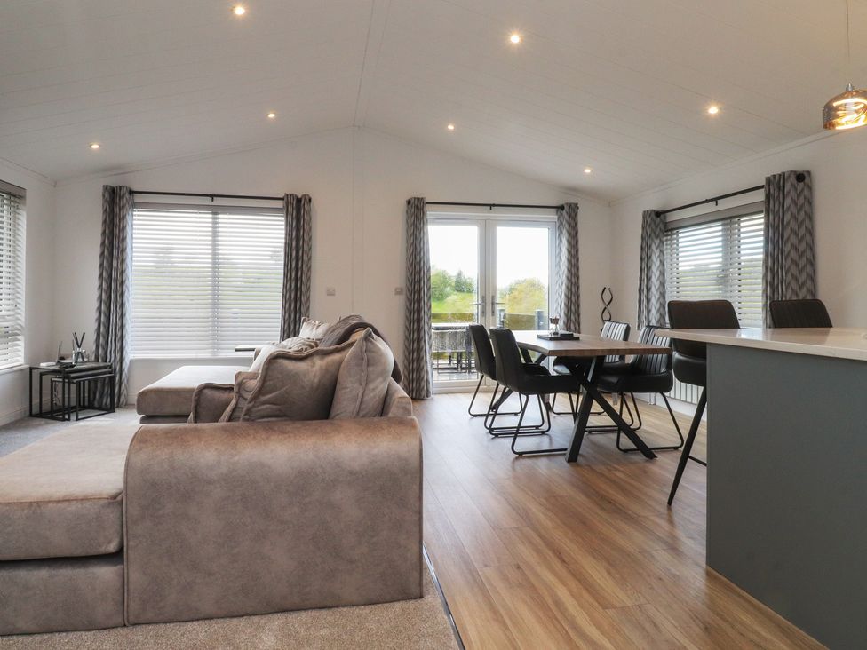 A living room with a sofa and dining area at Number 35