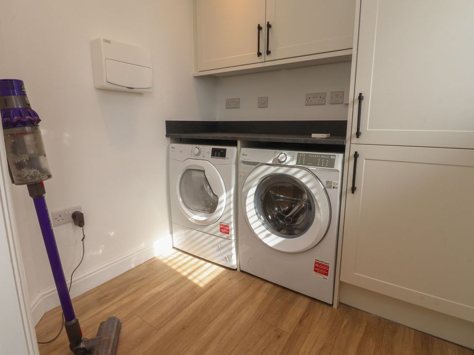 A washing machine and tumble dryer in a laundry room at Number 35