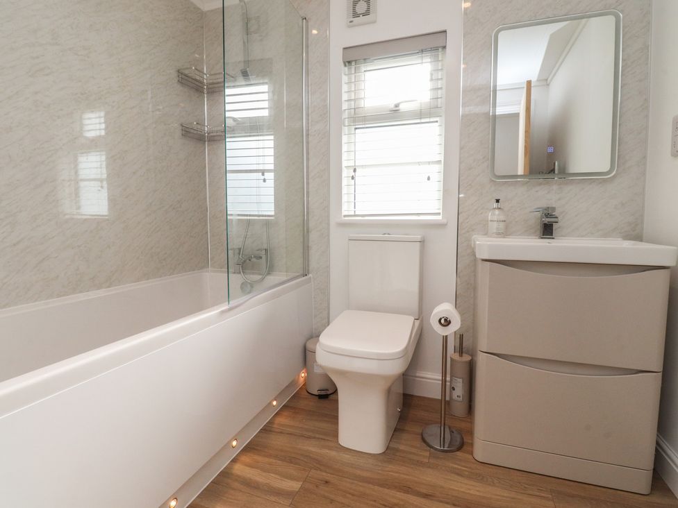 A bathroom with a bathtub and shower unit at Number 35
