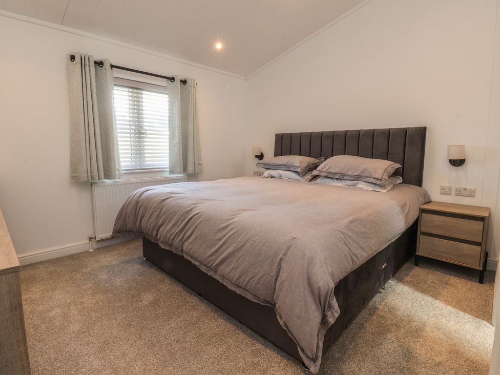 A bedroom with a large bed and window at Number 35