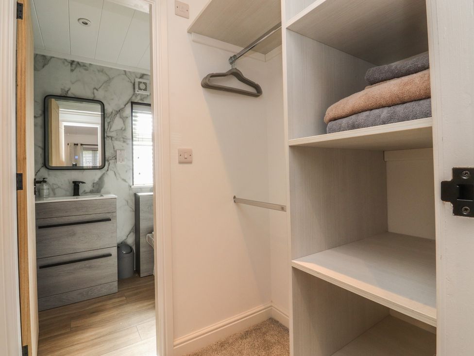 A bathroom with a mirror and sink in view at Number 35