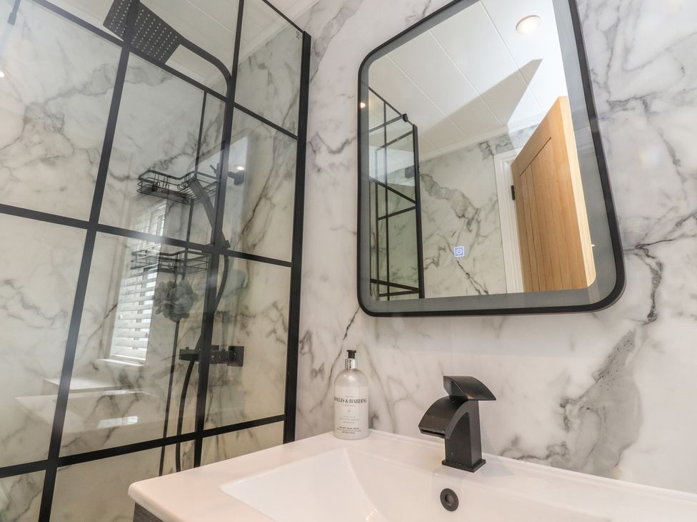A bathroom with a shower and sink at Number 35