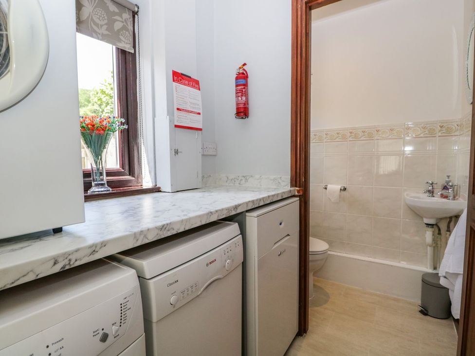 A laundry room with washing machine and dryer at Dolly Blue Backbarrow near Newby Bridge