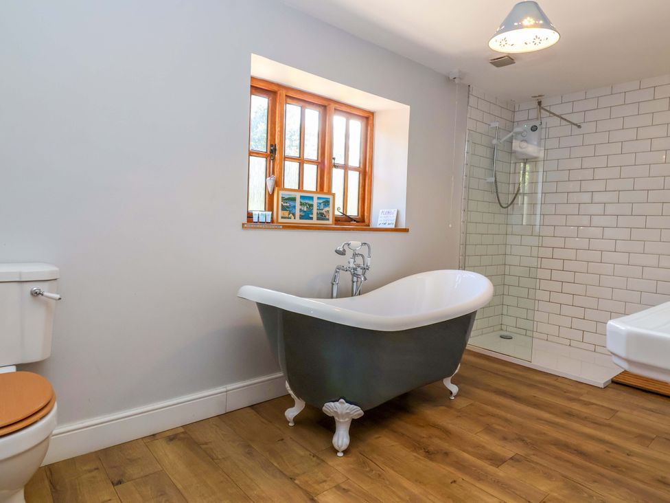 A bathroom with a bathtub and shower at Millbarn in Crowcombe