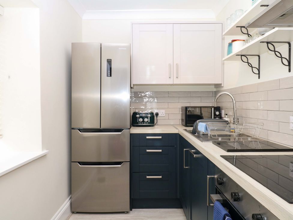 A kitchen with appliances and storage at 2 Sheplegh Court in Blackawton near Dartmouth