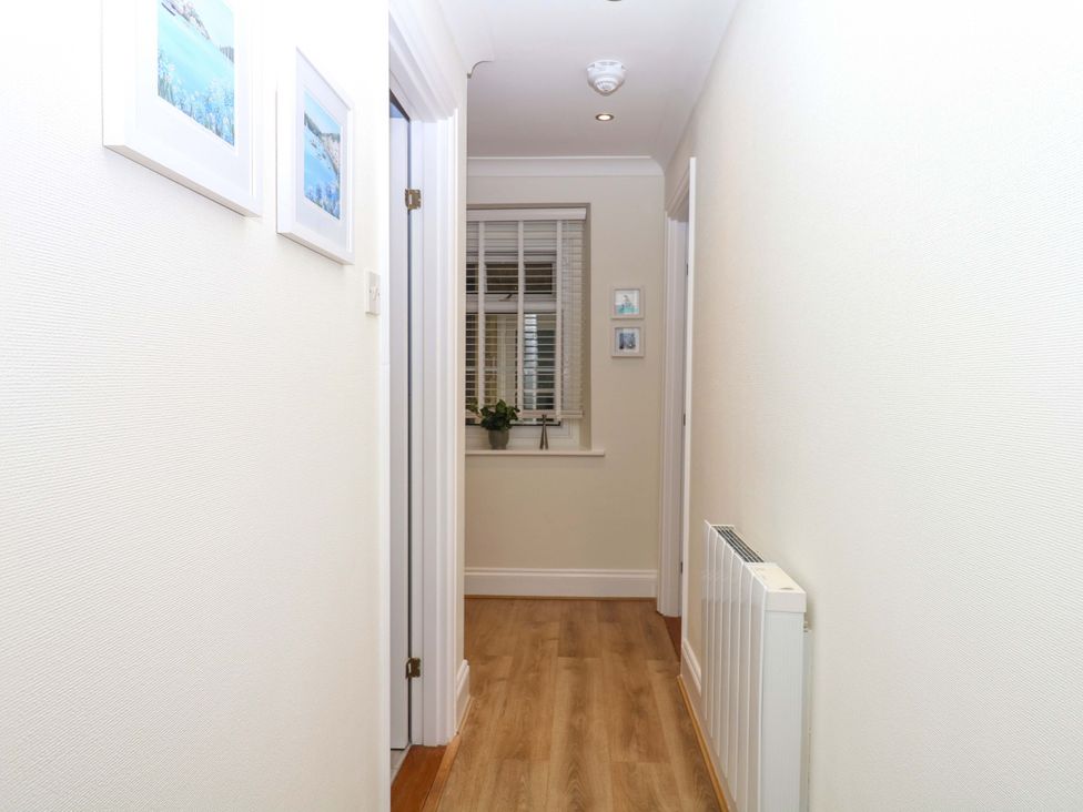 A hallway with a window and pictures on the wall at 2 Sheplegh Court Blackawton near Dartmouth