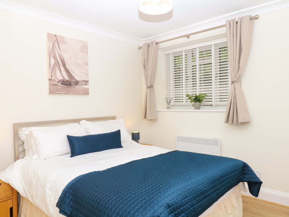A bedroom with a bed and painting at 2 Sheplegh Court near Dartmouth